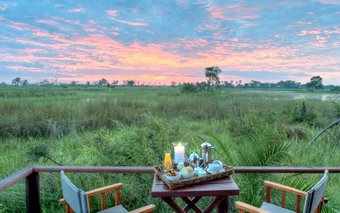 Photo of a distant sunset from Nxabega Okavango Tented Camp