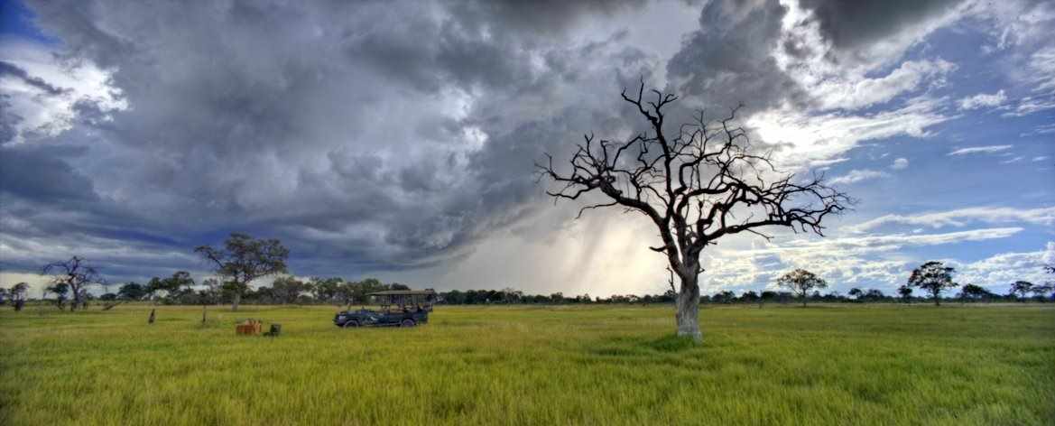 Picture of nearing storm and a prepared table for a bush dinner