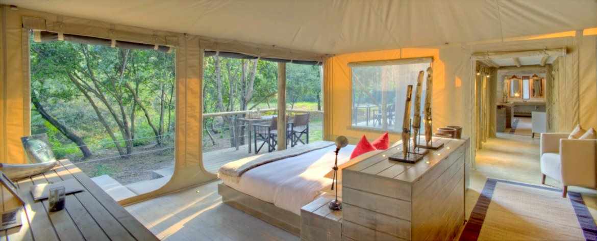A spacious tent suite with large windows and private deck.