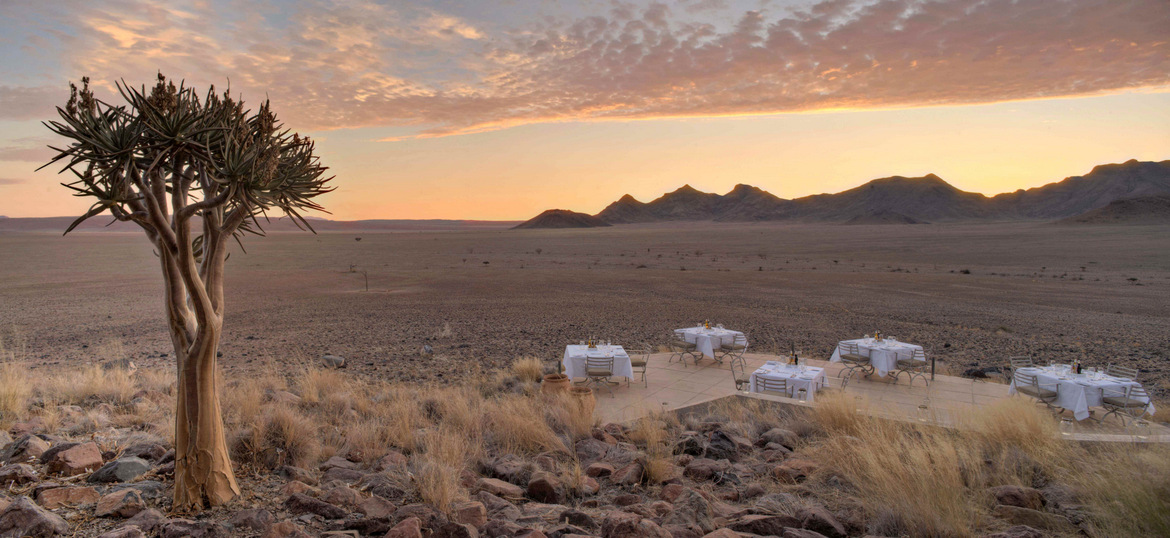 Guests standing and enjoying a drink in the desert.