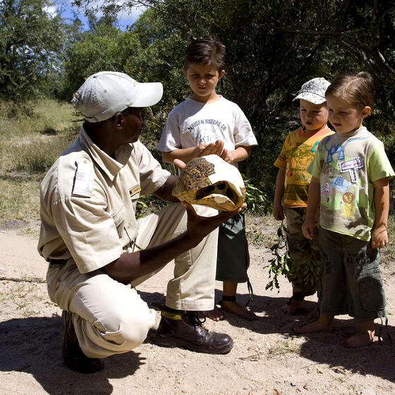 Photo of children and a game ranger