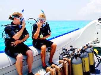 Scuba divers on the boat prepared for a dive.